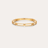 The Aisha Paperclip Stacking Ring in Gold features a delicate, open geometric link design—ideal as a dainty stacking ring and displayed on a simple, light background.