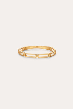 The Aisha Paperclip Stacking Ring in Gold features a delicate, open geometric link design—ideal as a dainty stacking ring and displayed on a simple, light background.