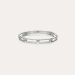 The Aisha Paperclip Stacking Ring in Silver showcases a sleek, open geometric link design and is displayed against a simple light backdrop.