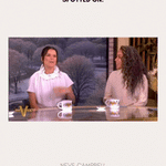 Two women sit at a desk on The View, smiling and talking. One wears the Esther Square Hoop Stud Earrings in Silver, lighting up the scene. Above them, text reads SPOTTED ON: and below, it says NEVE CAMPBELL.