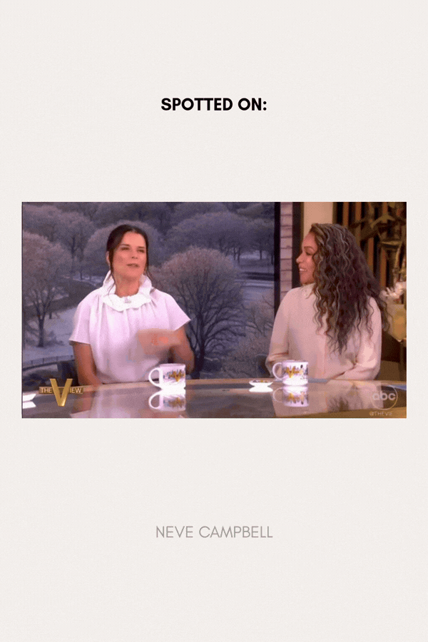 Two women sit at a desk on The View, smiling and talking. One wears the Esther Square Hoop Stud Earrings in Silver, lighting up the scene. Above them, text reads SPOTTED ON: and below, it says NEVE CAMPBELL.