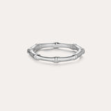 The Bamboo Ring in Silver is a slender band crafted from recycled sterling silver, featuring subtle joint details and showcased on a plain light background.