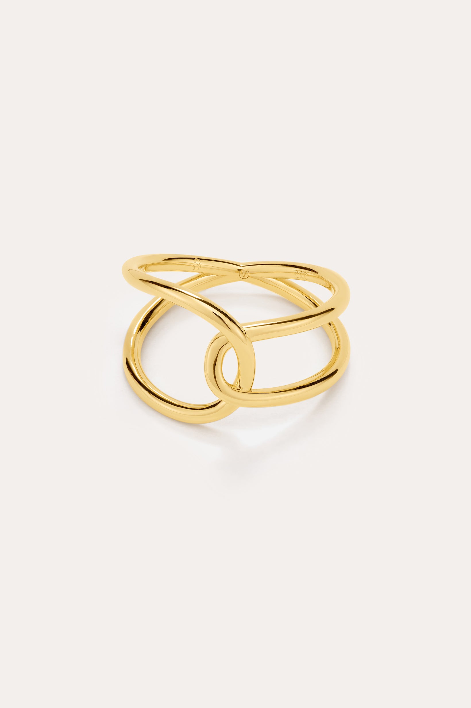 The Ayla Link Ring in Gold features an open, intertwined double-band design for a modern, elegant look, showcased against a plain, light background.