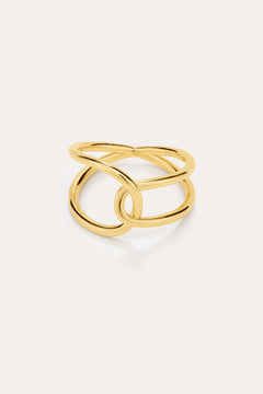 The Ayla Link Ring in Gold features an open, intertwined double-band design for a modern, elegant look, showcased against a plain, light background.