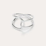 The Ayla Link Ring in Silver showcases a minimalist, modern design with two smooth, interlocking loops, set against a plain light background.