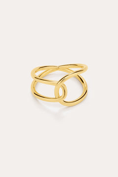 The Ayla Link Ring in Gold features a modern, intertwined double-band design plated in 18k gold, creating an elegant and minimalist loop pattern against a plain light background.