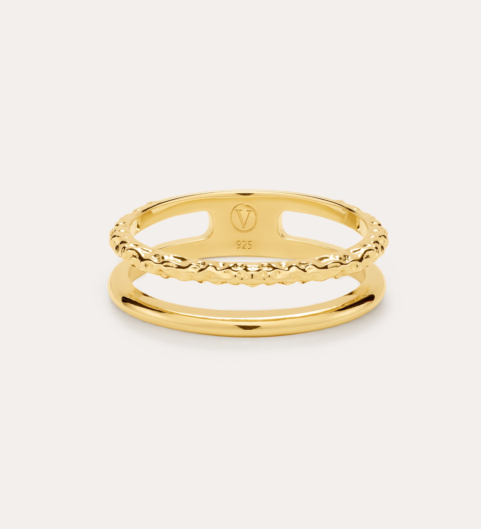 The Molten Double Band Ring in Gold, crafted in 18k gold plated with smooth and twisted rope bands, is elegantly displayed against a light background.