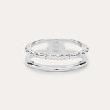 The Molten Double Band Ring in Sterling Silver features two parallel bands—one smooth, one twisted rope—connected at the sides. Stamped 925 and with a geometric logo, it's perfect for everyday wear on a light background.