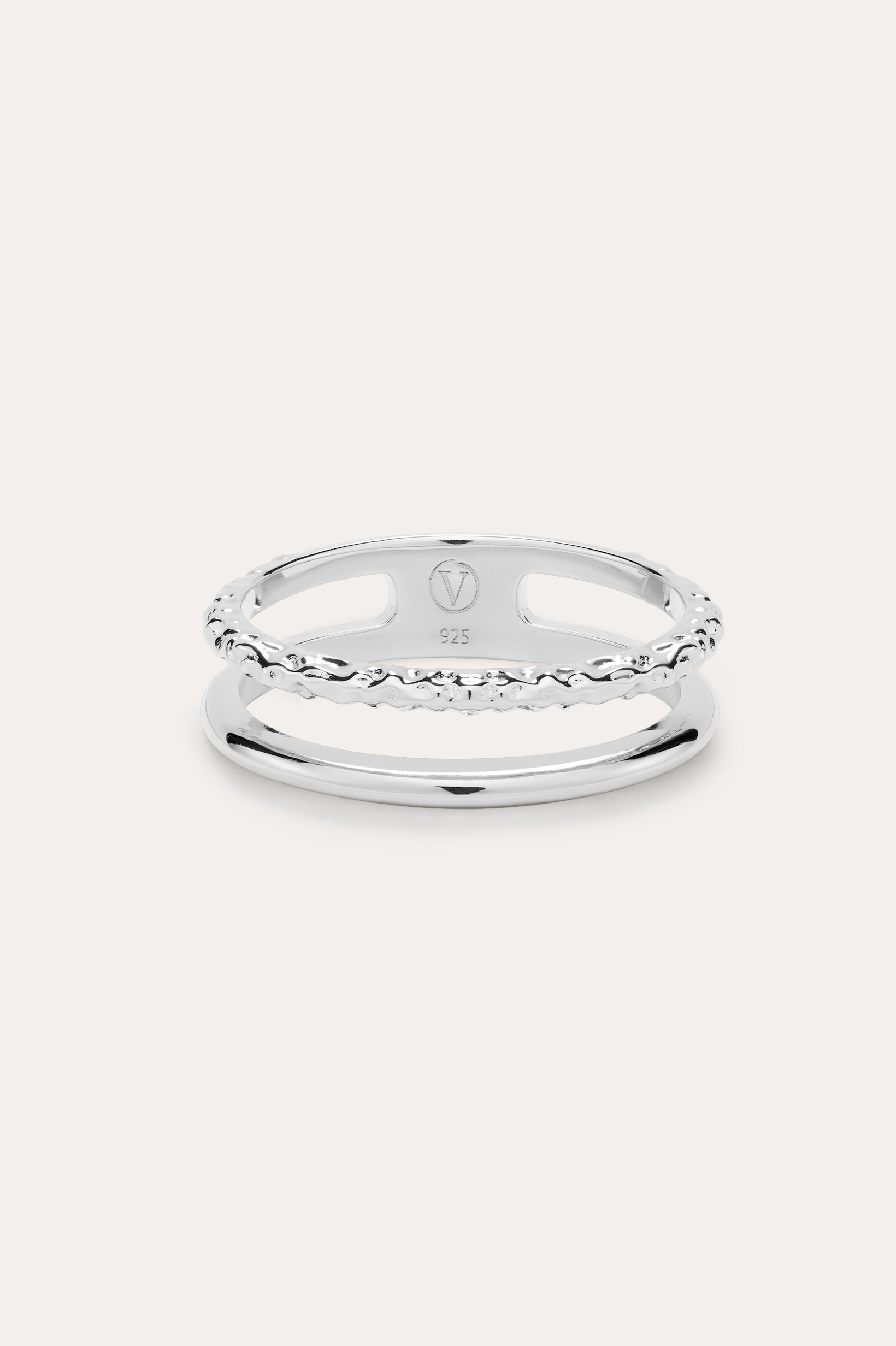 The Molten Double Band Ring in Sterling Silver features two parallel bands—one smooth, one twisted rope—connected at the sides. Stamped 925 and with a geometric logo, it's perfect for everyday wear on a light background.