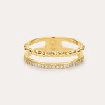 The Molten Crystal Double Band Ring in Gold features 18k gold plating, two connected bands—one with a twisted rope design and the other adorned with cubic zirconia—shown against a light background.