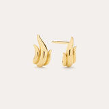 A pair of Flame Stud Earrings in Gold with a sculptural, flame-inspired design and 18k gold plated finish are shown on a light background—one facing forward and the other displaying the side and post.