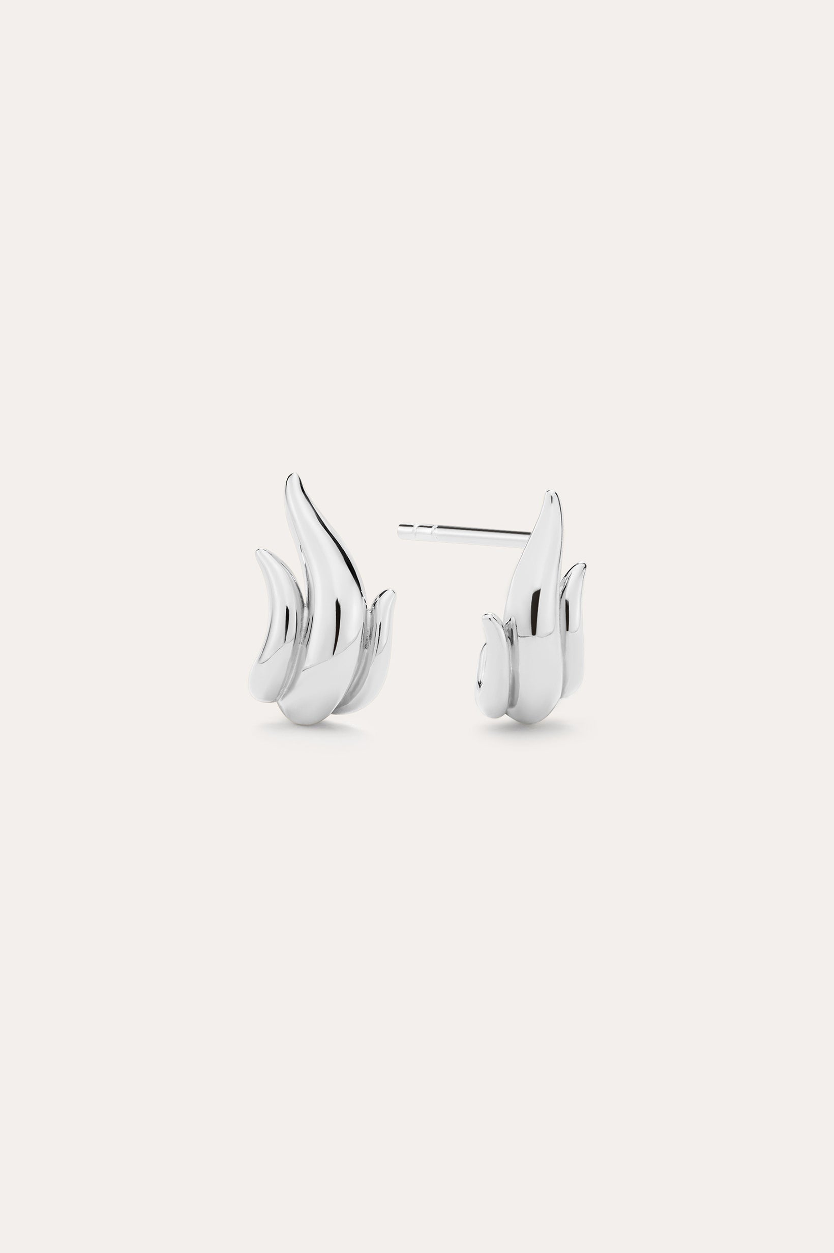 Flame Stud Earrings in Silver, crafted in sterling silver and shaped like stylized flames, are shown on a plain light background with one front view and one side view—ideal for fans of modern jewellery.