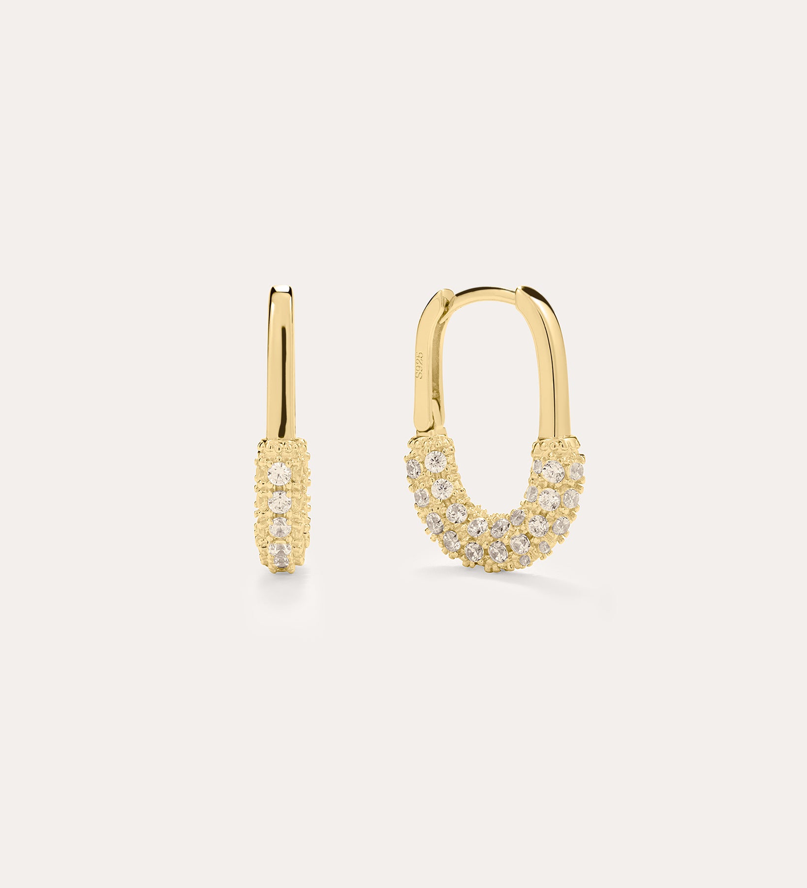 The Nouf Pavé Hoop Earrings in 18k Gold Plated feature small hoops encrusted with sparkling cubic zirconia along the lower half, shown on a plain light background.