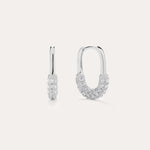The Nouf Pavé Hoop Earrings in Sterling Silver, partially adorned with sparkling cubic zirconia, are shown on a plain light background—one earring displayed from the front, the other from the side.