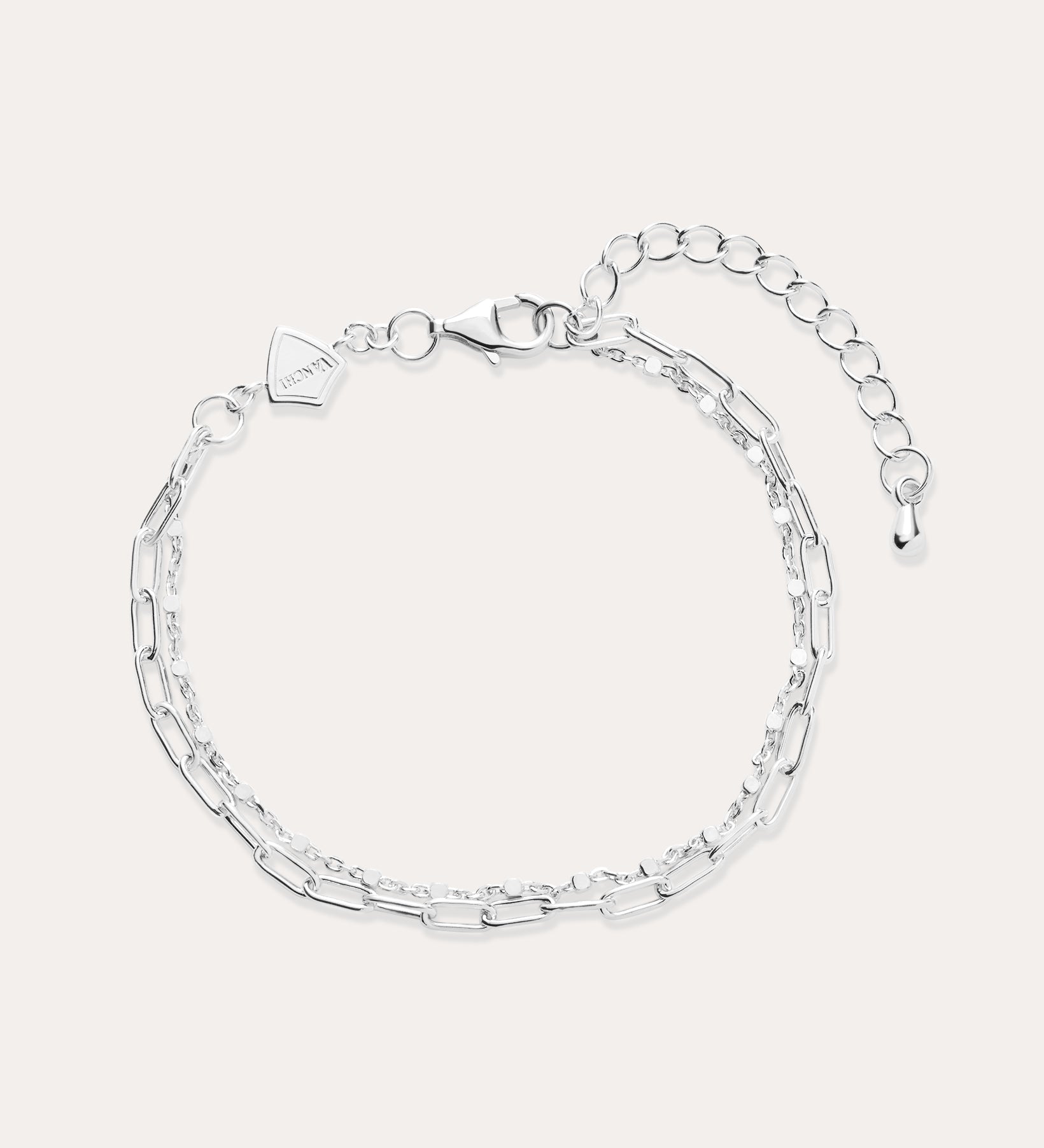The Mini Paperclip Double Chain Bracelet in Sterling Silver features two contrasting chain styles—small and elongated links—an adjustable clasp, and a petite hexagonal charm.