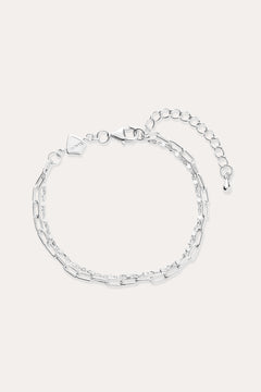 The Mini Paperclip Double Chain Bracelet in Sterling Silver features two contrasting chain styles—small and elongated links—an adjustable clasp, and a petite hexagonal charm.