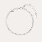The Figaro And Box Chain Layered Bracelet in Sterling Silver features an adjustable extension, lobster clasp, and a small geometric charm. Shown on a light background, this delicate bracelet is perfect for everyday wear.