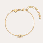 The Defender Evil Eye Bracelet in Gold features an 18k gold-plated finish, an eye-shaped cubic zirconia charm with three dangling crystals, and an adjustable lobster clasp closure.