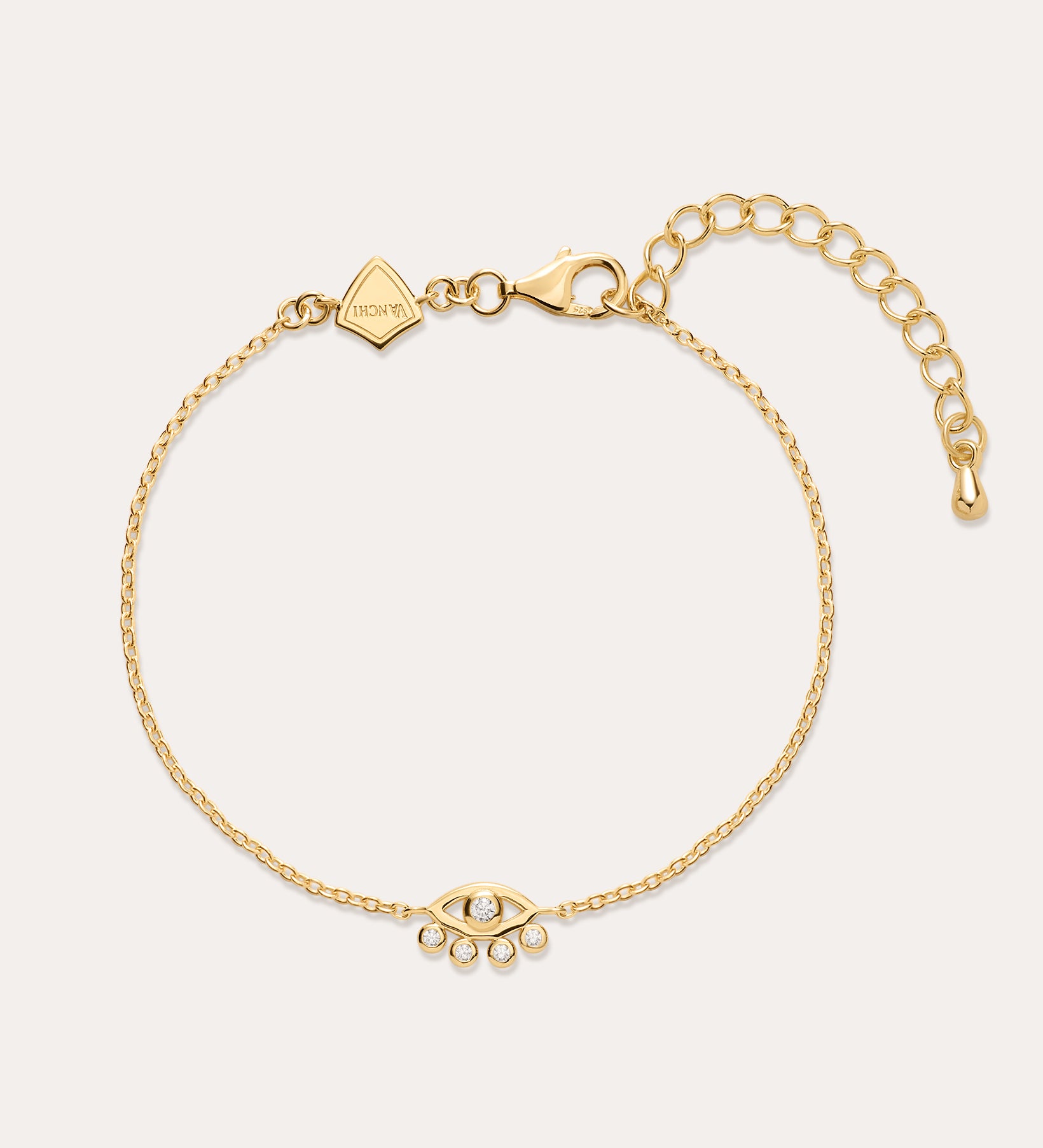 The Defender Evil Eye Bracelet in Gold features an 18k gold-plated finish, an eye-shaped cubic zirconia charm with three dangling crystals, and an adjustable lobster clasp closure.