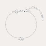 The Defender Evil Eye Bracelet in Sterling Silver features a central charm with clear cubic zirconia, an adjustable extension chain, lobster clasp, and a small square tag near the clasp.
