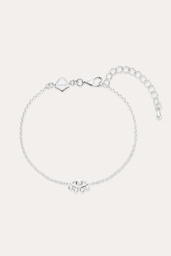 The Defender Evil Eye Bracelet in Sterling Silver features a central charm with clear cubic zirconia, an adjustable extension chain, lobster clasp, and a small square tag near the clasp.