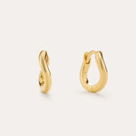 The Nori Mini Twisted Huggies in Gold are 18k gold plated earrings with a smooth, twisted design, beautifully shown on a light beige background.