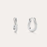 The Nori Mini Twisted Huggies in Sterling Silver feature a sculptural twisted hoop design and are shown against a light, plain background.