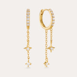 The Star Double Chain Dangle Huggies in Gold feature 18k gold plating with two star-shaped charms on each chain drop and sparkling cubic zirconia for an elegant, delicate look.