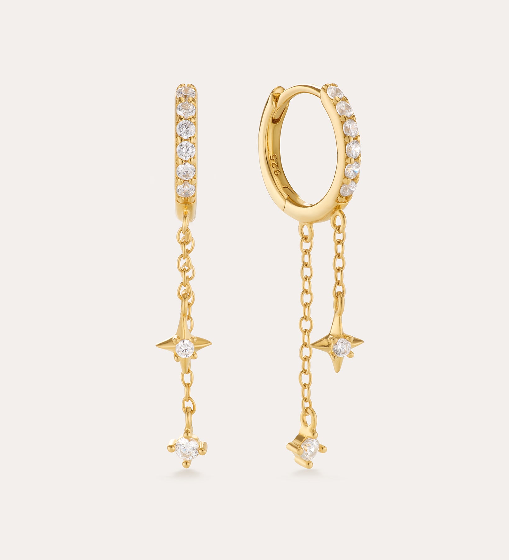 The Star Double Chain Dangle Huggies in Gold feature 18k gold plating with two star-shaped charms on each chain drop and sparkling cubic zirconia for an elegant, delicate look.