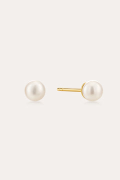 The Freshwater Pearl Studs in Gold feature round white pearls on 18k gold plated posts, shown against a plain light background.