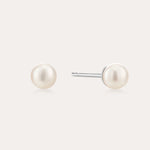 A pair of Freshwater Pearl Studs in Gold featuring round white pearls on sterling silver posts, shown against a plain light background.