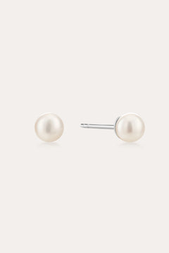 A pair of Freshwater Pearl Studs in Gold featuring round white pearls on sterling silver posts, shown against a plain light background.