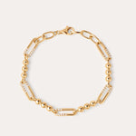The Carly Paperclip Chain Bead Bracelet in Gold features alternating large 18k gold plated links, some adorned with sparkling cubic zirconia and sections of round gold beads, finished with a lobster clasp.