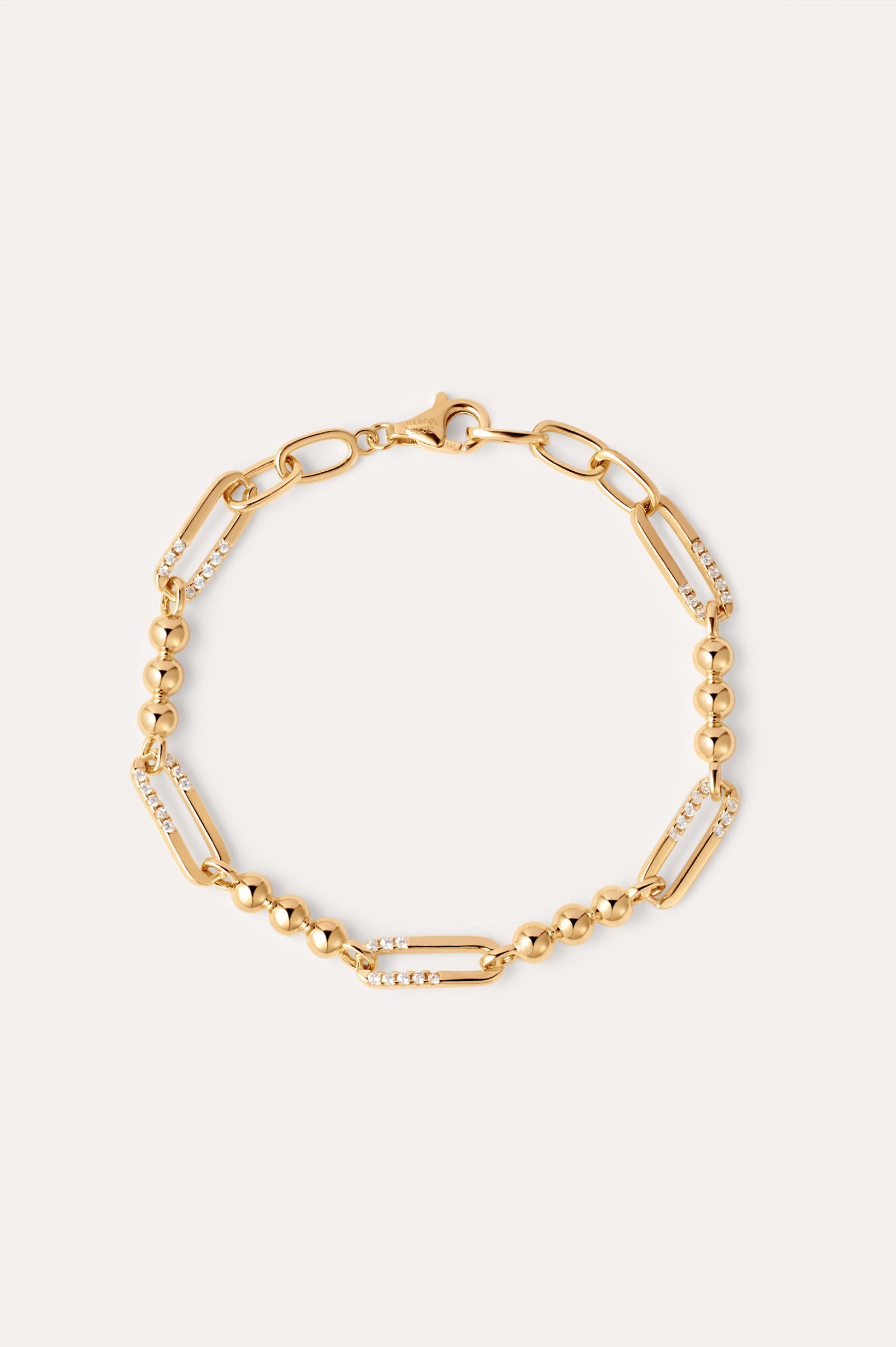 The Carly Paperclip Chain Bead Bracelet in Gold features alternating large 18k gold plated links, some adorned with sparkling cubic zirconia and sections of round gold beads, finished with a lobster clasp.