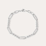 The Carly Paperclip Chain Bead Bracelet in Silver features alternating elongated oval links and small round beads, showcased in a circular arrangement on a plain light background.