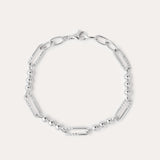The Carly Paperclip Chain Bead Bracelet in Silver features alternating elongated oval links and small round beads, showcased in a circular arrangement on a plain light background.