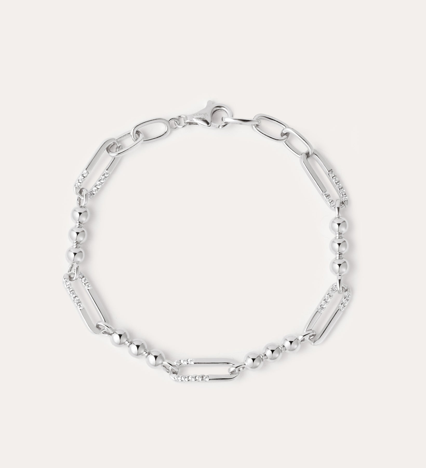 The Carly Paperclip Chain Bead Bracelet in Silver features alternating elongated oval links and small round beads, showcased in a circular arrangement on a plain light background.