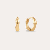 The Colette Droop Link Huggie Earrings in Gold feature smooth, rounded organic curves, showcased against a plain light background.