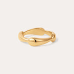 The Colette Link Droop Ring in Gold, featuring a wavy, organic design, is displayed against a simple, light background.