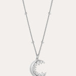 The Crescent Moon Crystal Charm Beaded Necklace in Silver features a delicate beaded chain and a crescent moon pendant adorned with sparkling clear stones.