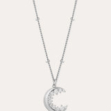 The Crescent Moon Crystal Charm Beaded Necklace in Silver features a delicate beaded chain and a crescent moon pendant adorned with sparkling clear stones.