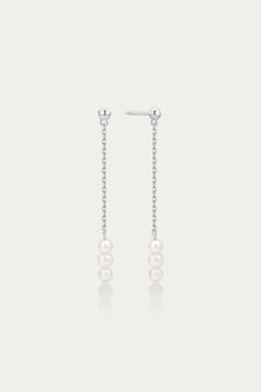 Pair of pearl drop earrings on a light gray background