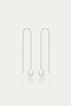 The Eira Pearl Drop Threader Earrings in Silver feature elegant thin chains with a single white pearl at each end, shown on a plain white background.