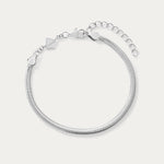 The Estelle Herringbone Chain Bracelet in Silver features a 3mm sleek chain, an adjustable extension, and a small charm by the clasp, shown against a plain white background.
