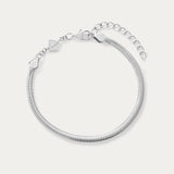 The Estelle Herringbone Chain Bracelet in Silver features a 3mm sleek chain, an adjustable extension, and a small charm by the clasp, shown against a plain white background.