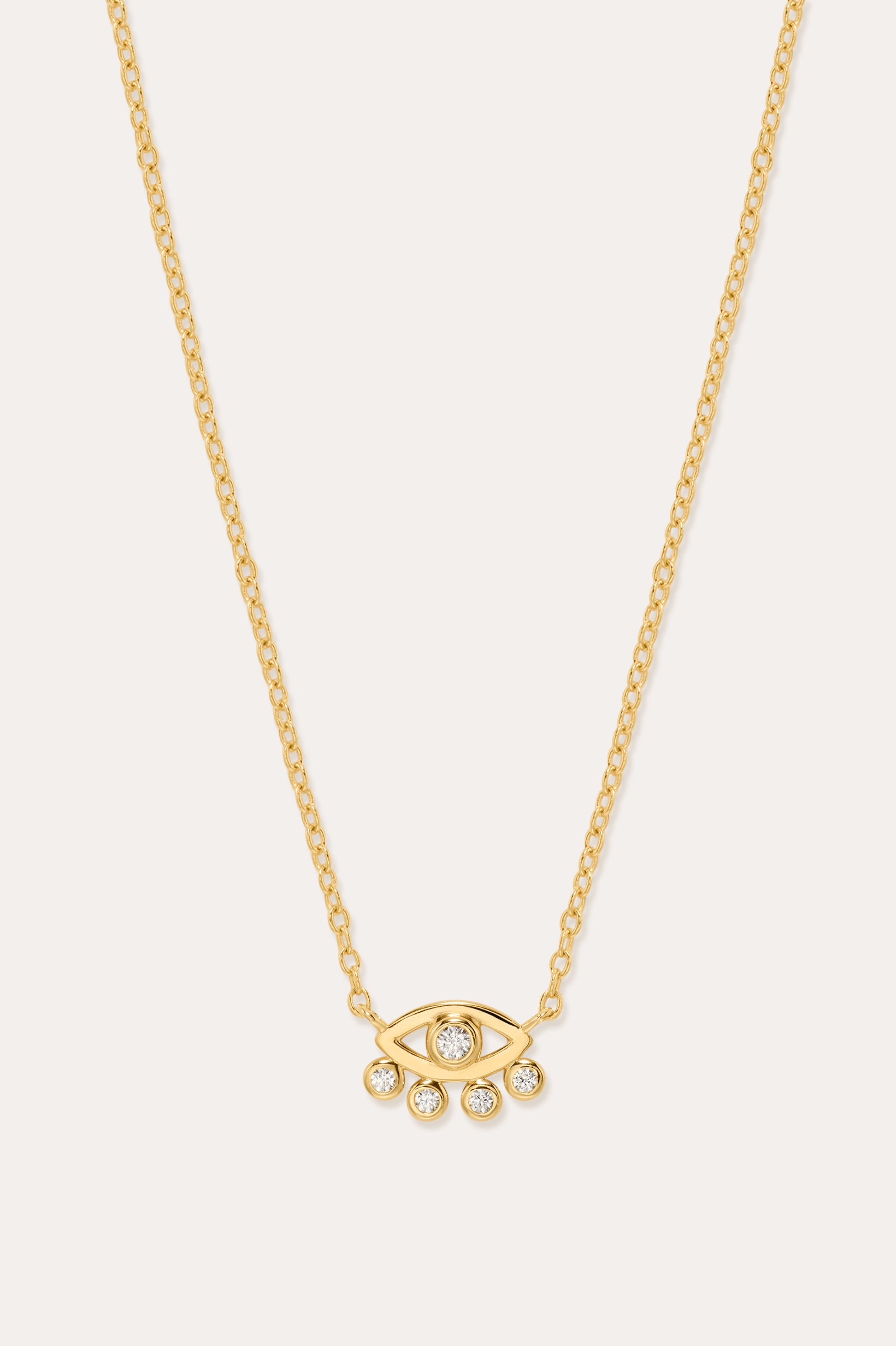 The Defender Evil Eye Necklace in Gold features an 18k gold-plated eye-shaped pendant with a central cubic zirconia and four dangling crystals, shown on a plain white background.