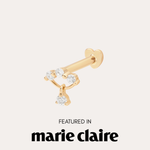 The 14K Solid Yellow Gold Freda Lab-grown Diamond Flat Back Stud, featuring three round diamonds and a dangling diamond, is shown above "Featured in marie claire" on a light background.