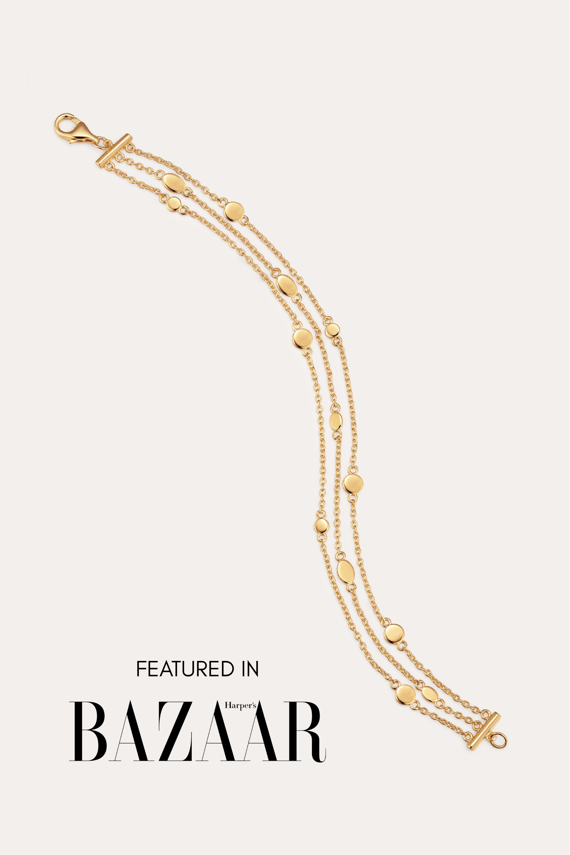 The Simone Triple Chain Layered Bracelet in Gold, featuring delicate 18k gold plating and small round accents, is shown against a plain light background. Text at the bottom reads: FEATURED IN Harper’s BAZAAR.