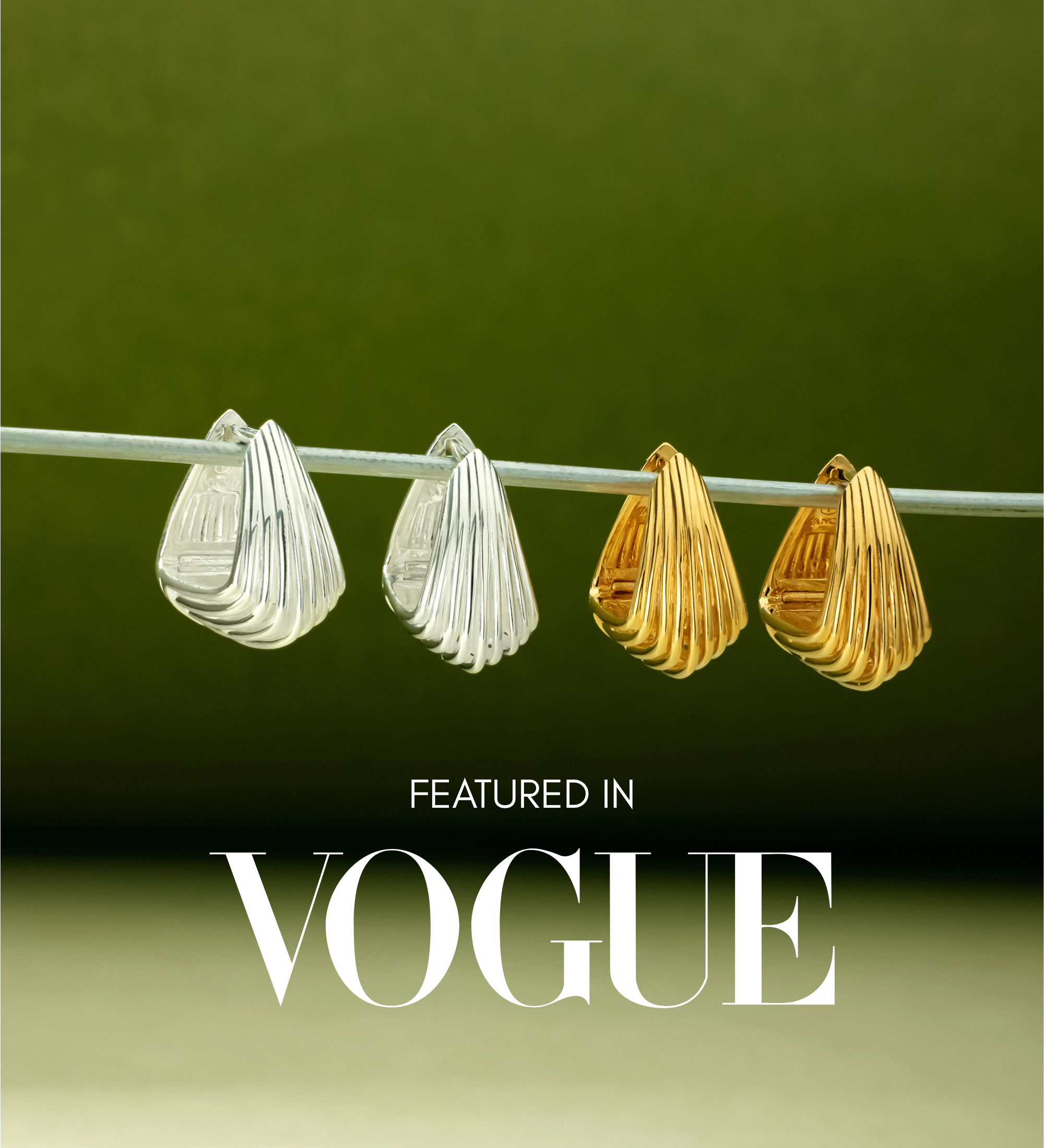 Two pairs of sculptural hoop earrings, including the Juno Ridged Chunky Hoops in Gold, hang on a clear rod against a green background. The text Featured in VOGUE appears at the bottom of the image.