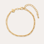 The Figaro And Box Chain Layered Bracelet in 18k Gold Plated features two intertwined strands in a mini Figaro box chain design with a lobster clasp, adjustable extender, and geometric tag, shown on a plain off-white background.